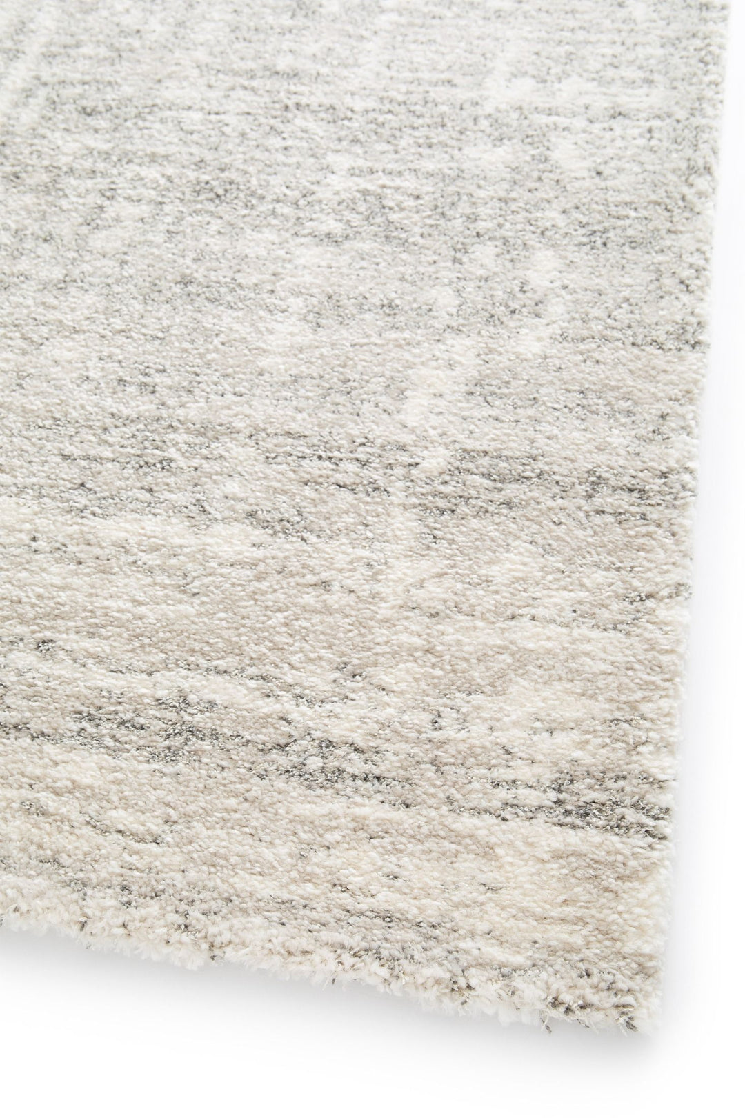 Detailed view of a plush grey patterned rug.