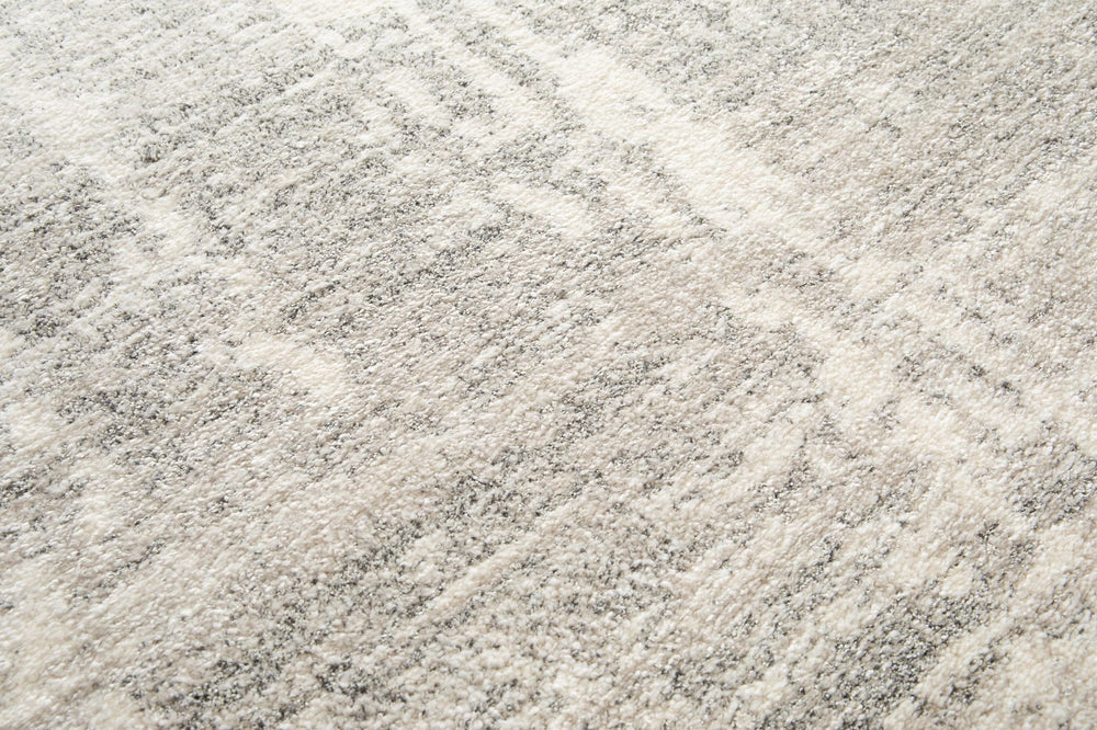 Close-up of grey rug texture with soft fibers.