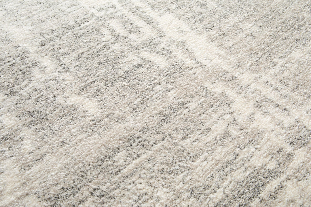 Close-up of grey rug texture with soft fibers.