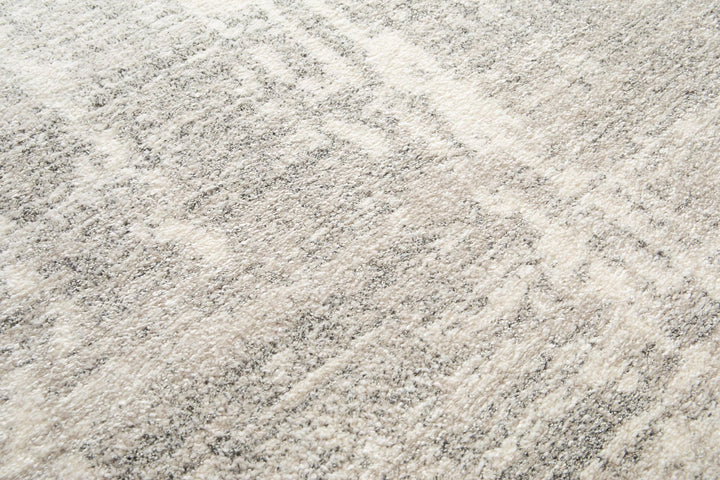 Close-up of grey rug texture with soft fibers.