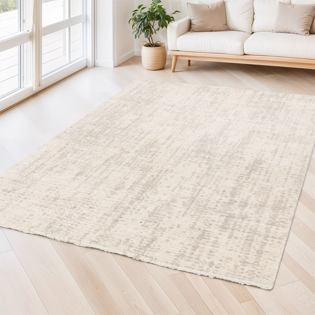 Beige rug styled in a bright living room.