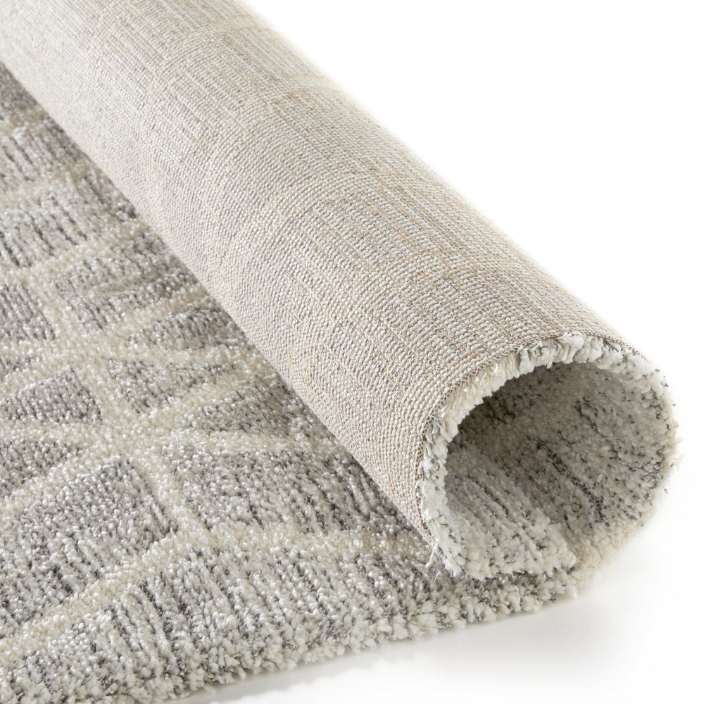 Rolled rug showing both front and backing.