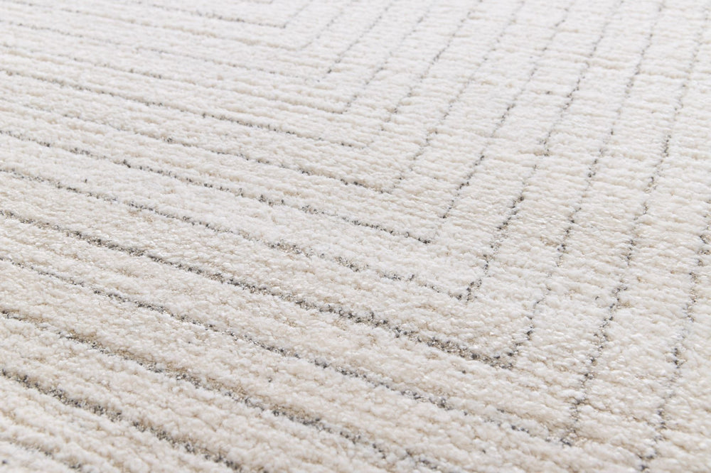 Close-up detail of a cream rug with raised textured stripes.