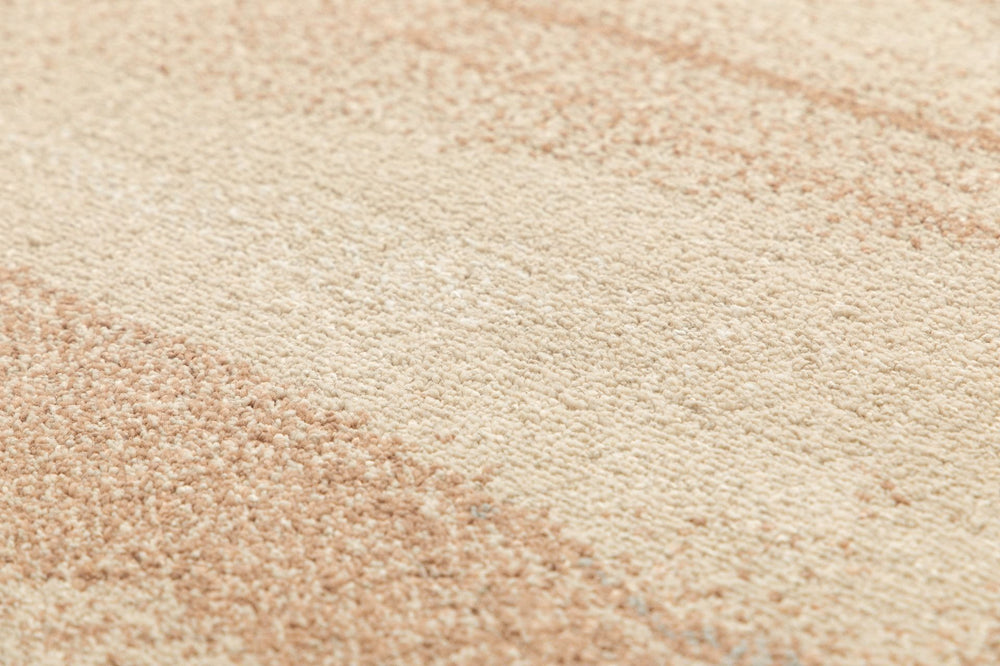 Close-up of rug fibers in beige and brown tones.