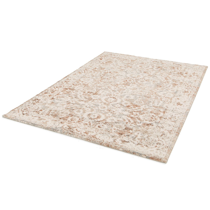 Full angled view of a beige and rust area rug.