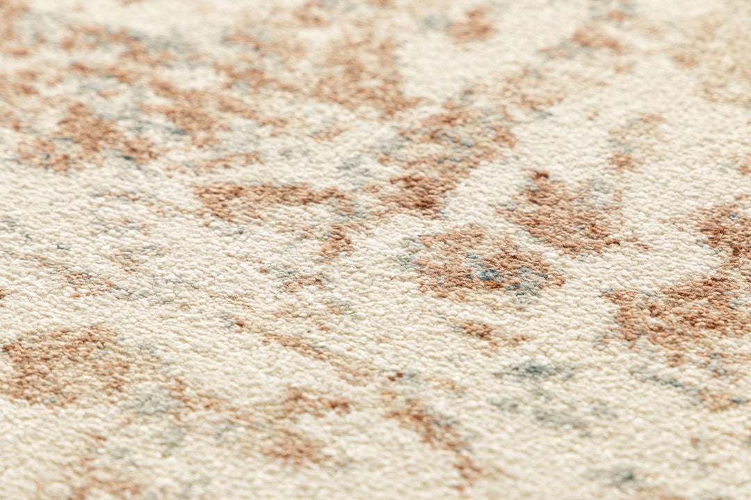 Full top view of a beige rug with ornate rust and blue accents.