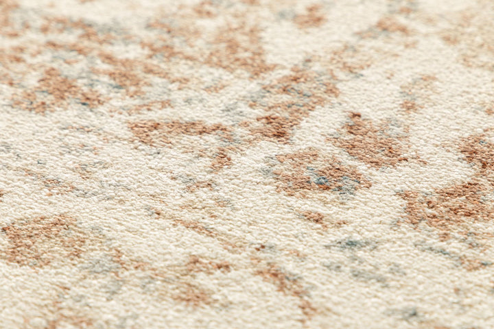 Full top view of a beige rug with ornate rust and blue accents.