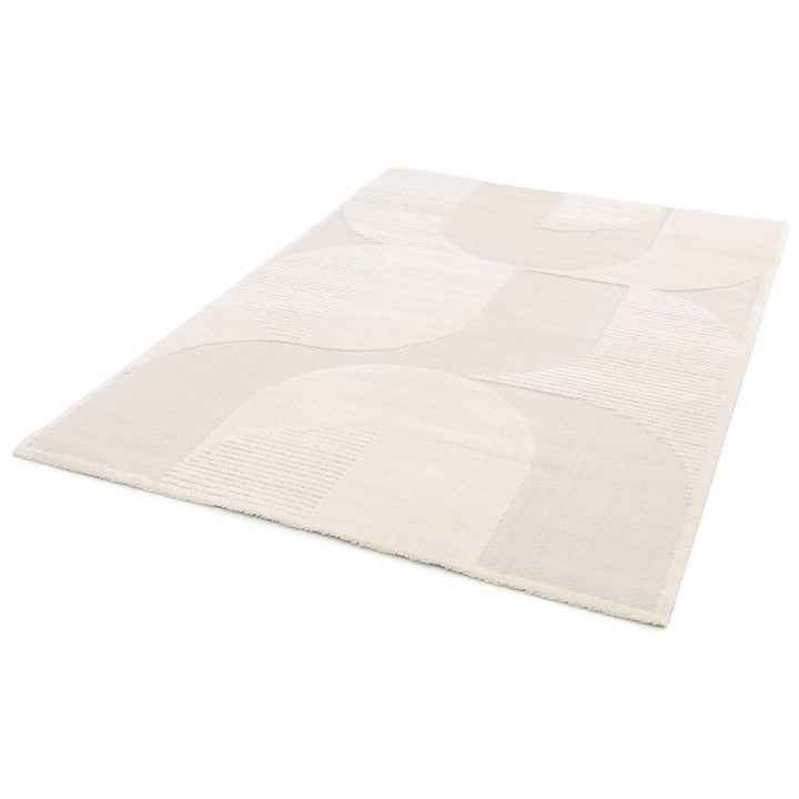 Cream rug with geometric patterns displayed at an angle.