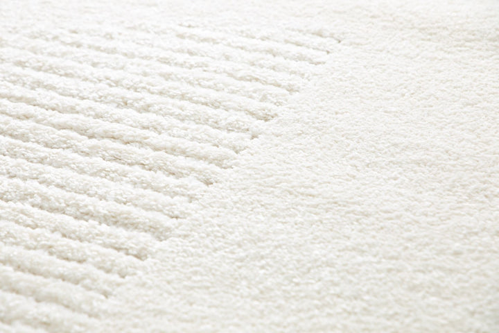 Close-up of cream rug showing textured stripes.