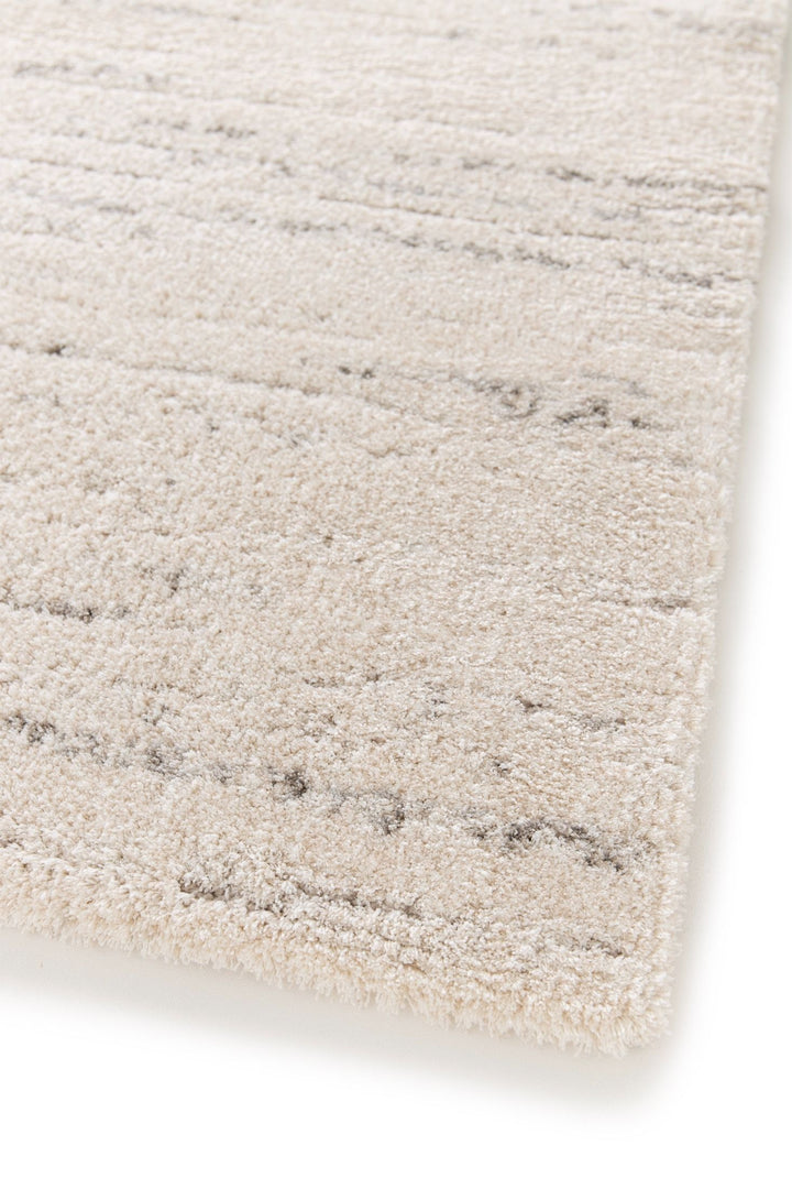 Angled close-up of cream rug texture with grey accents.