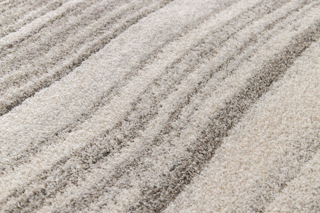 Close-up of soft rug surface with grey stripes.