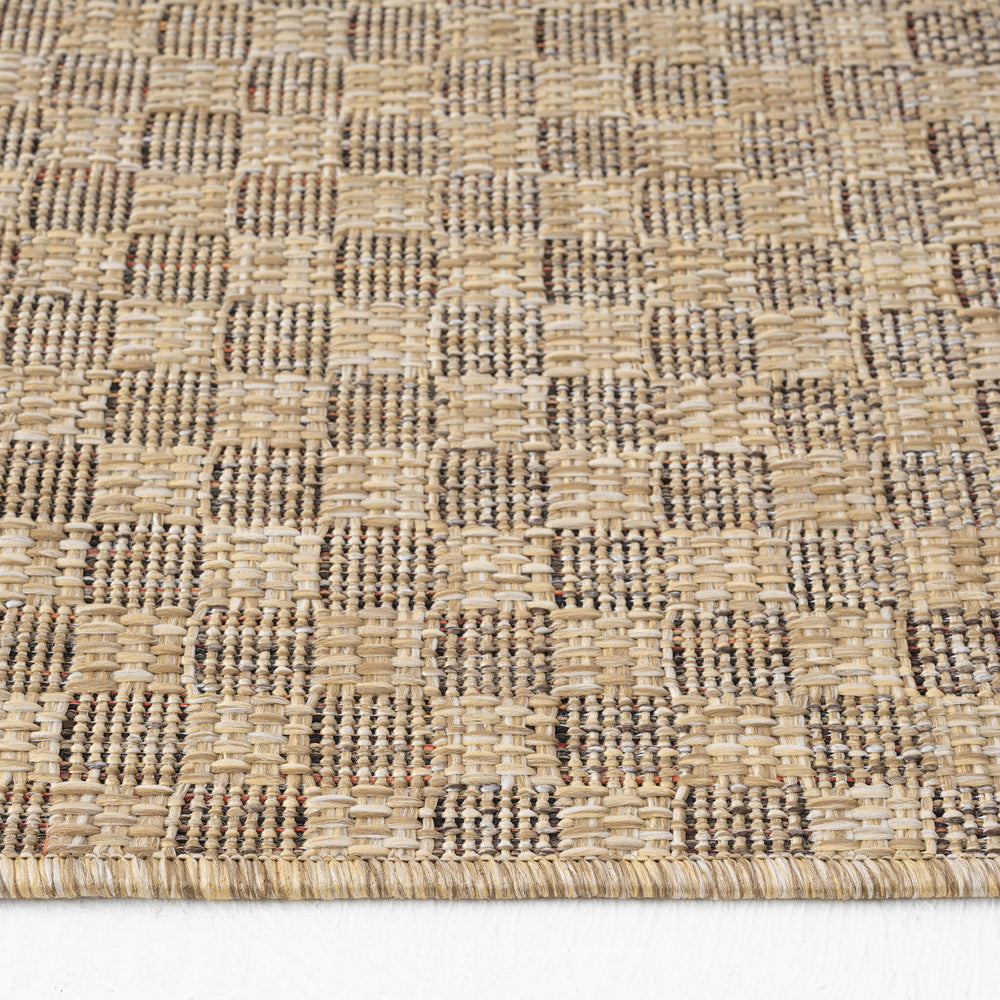 Close-up of a woven textured mat with a geometric pattern on a white background