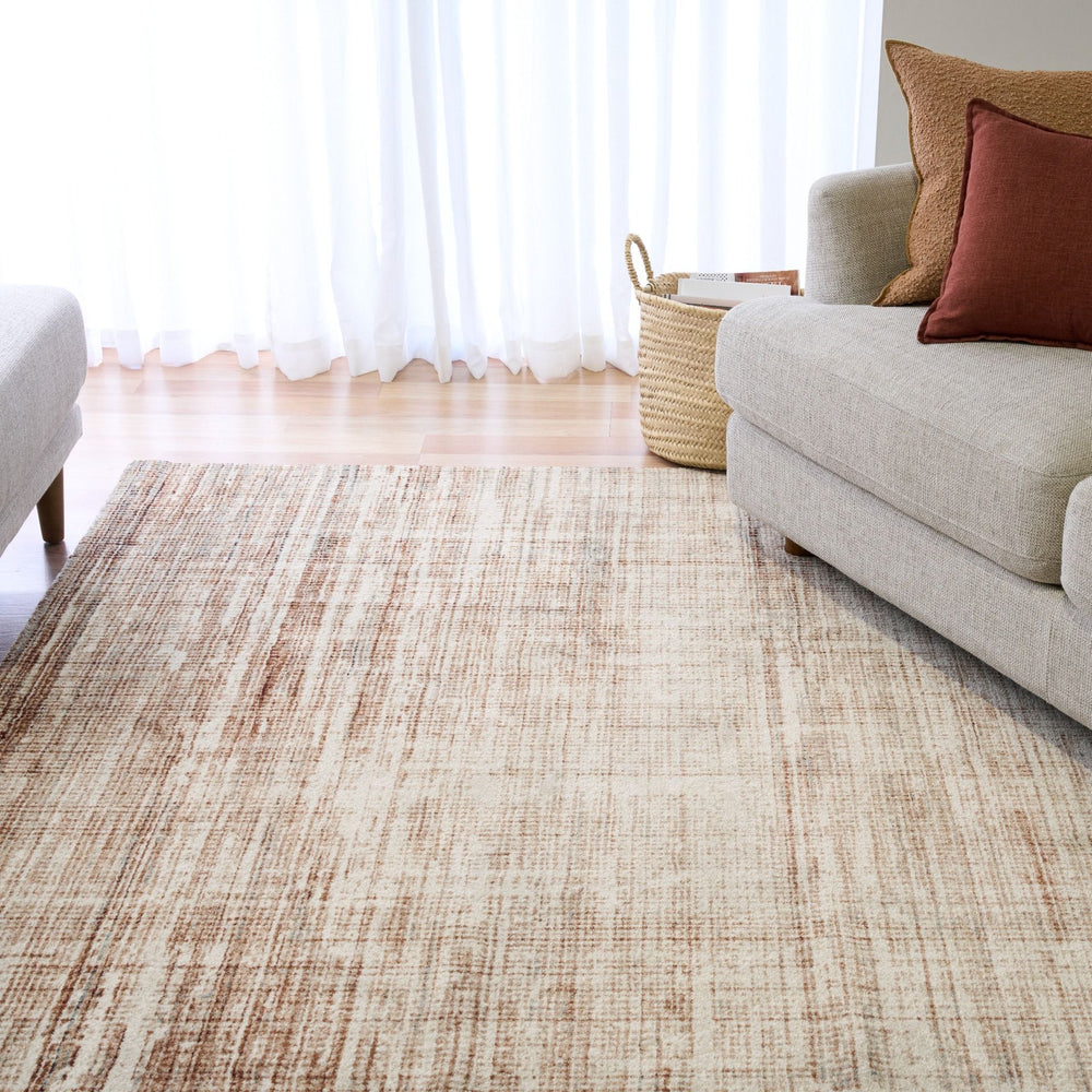 A brown crosshatch rug placed in a bright living room.