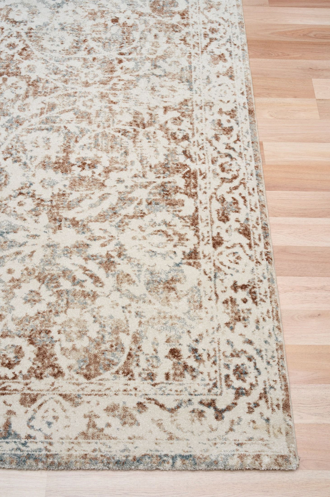 Beige and brown area rug shown at an angle.