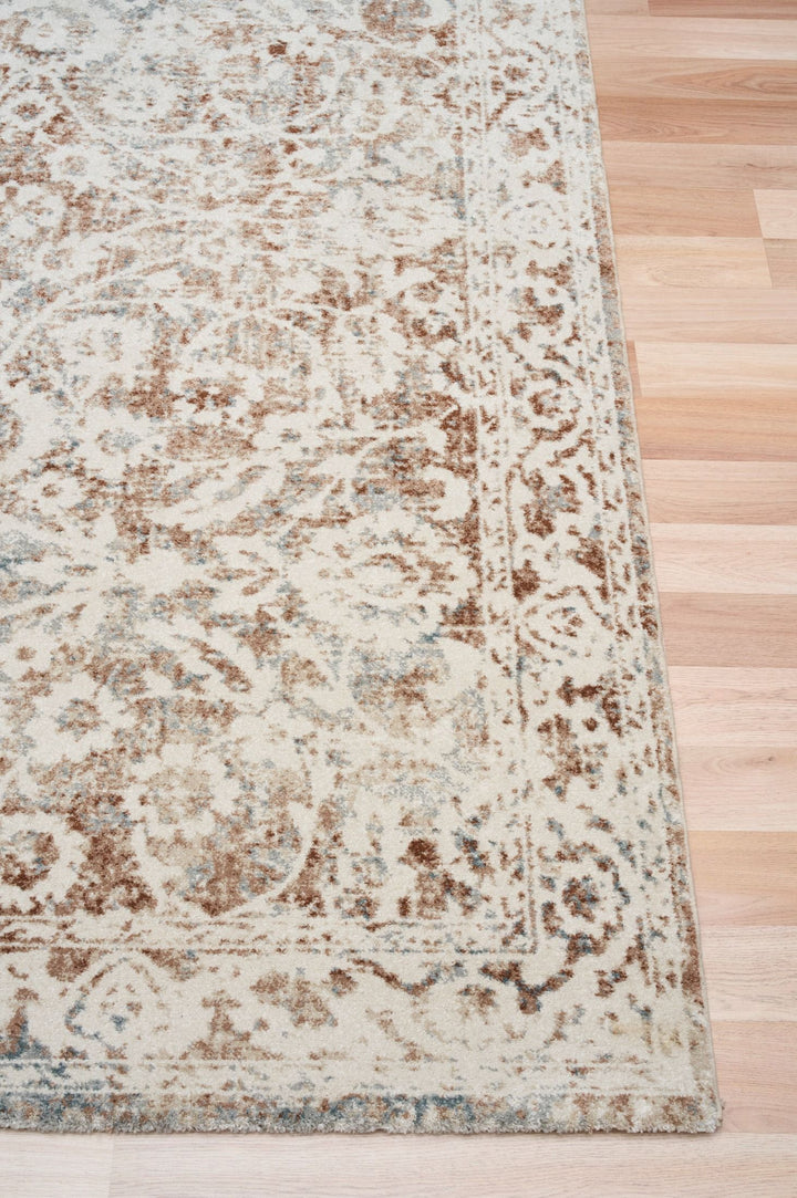 Beige and brown area rug shown at an angle.