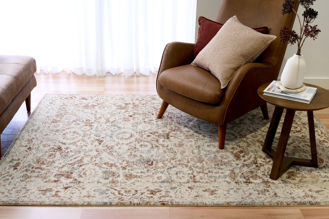 Close-up texture of a beige and brown patterned rug.