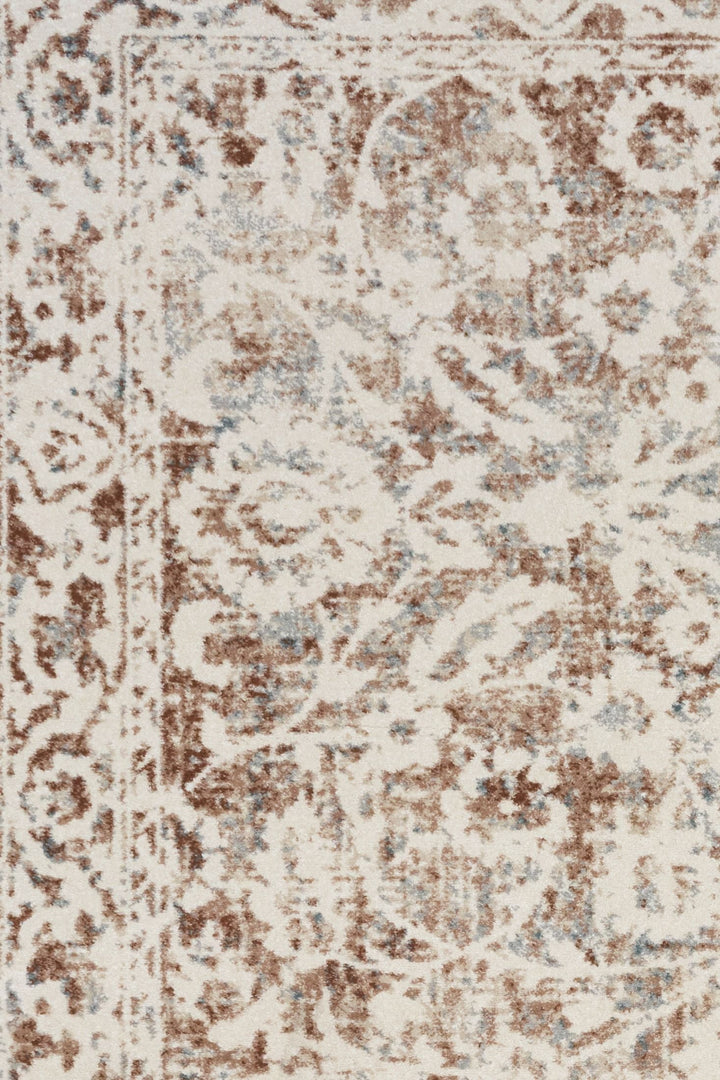 Beige and brown patterned rug laid flat.