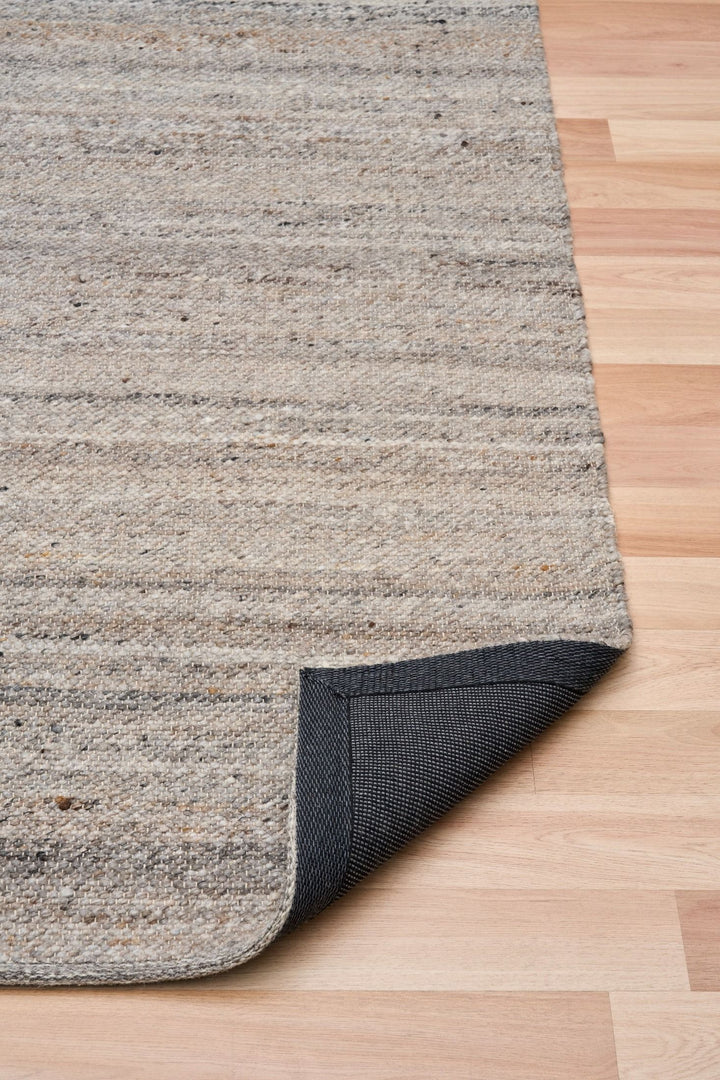 Close-up of rug corner folded to show woven backing detail.