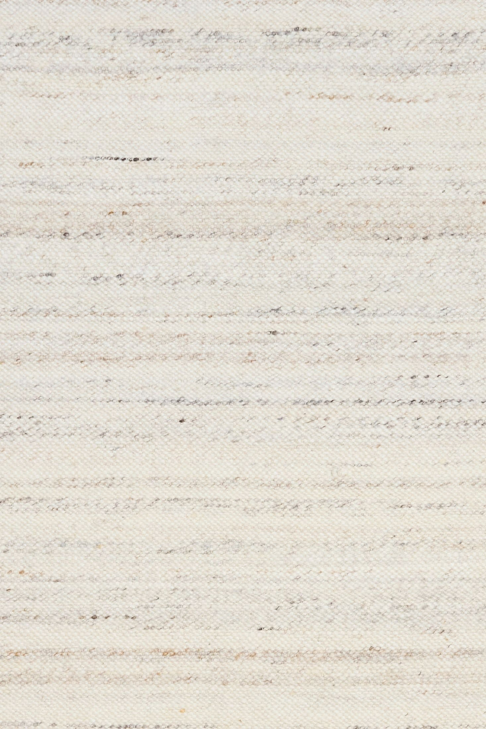 Detailed close-up of ivory woven rug texture with subtle grey and beige speckles.