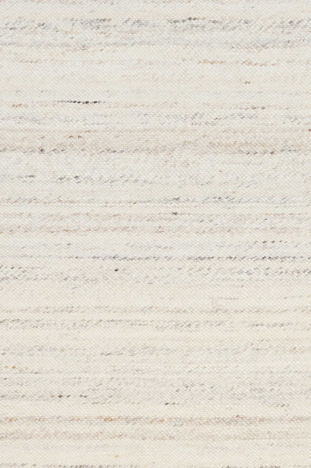 Detailed close-up of ivory woven rug texture with subtle grey and beige speckles.