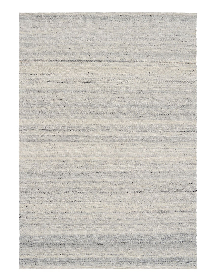 Rectangular silver rug with subtle gradient design displayed flat on the floor.