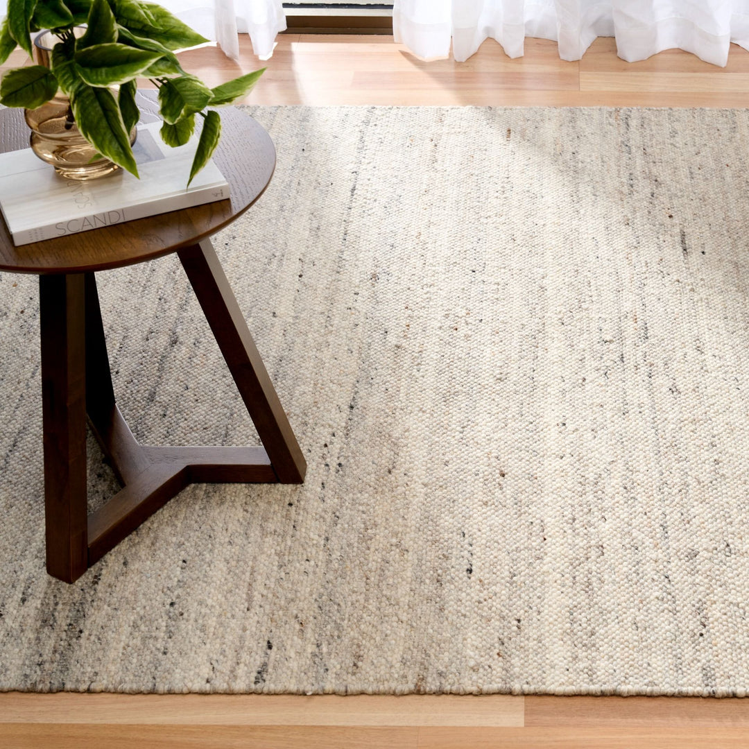 A square cropped view of the Harmony Smoke Grey rug in a bright living room.