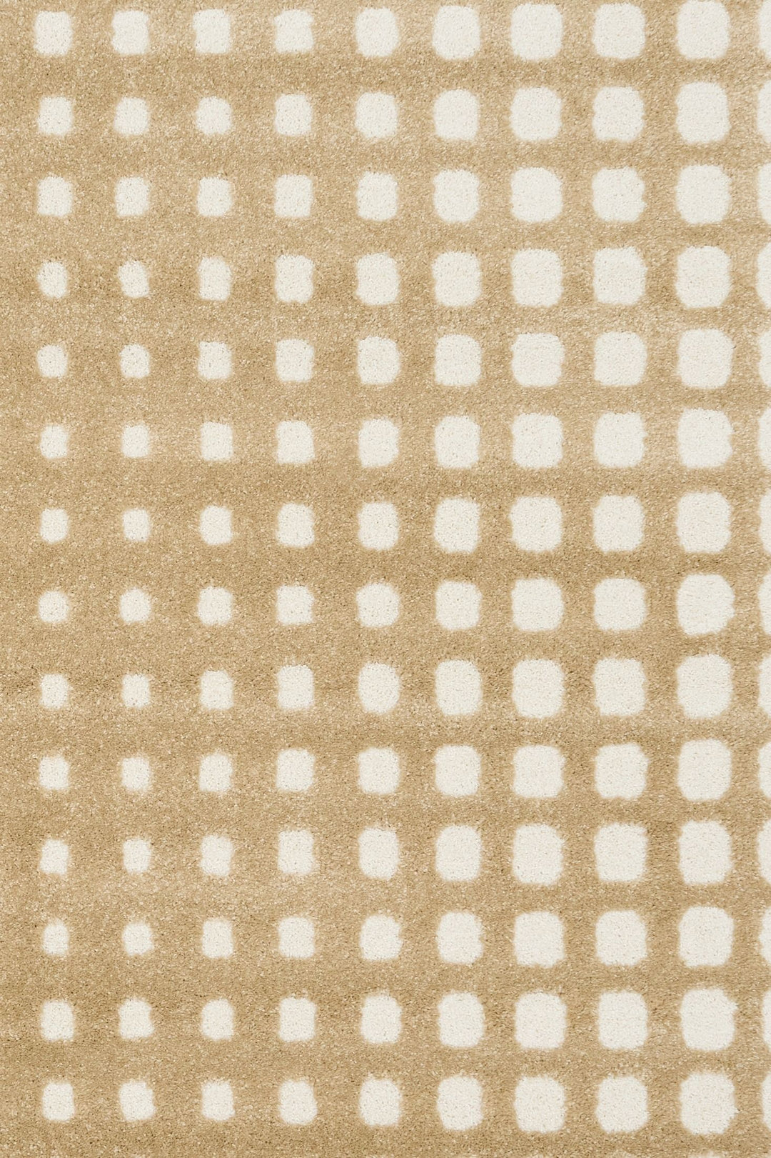 Detailed view of beige rug’s textured squares.
