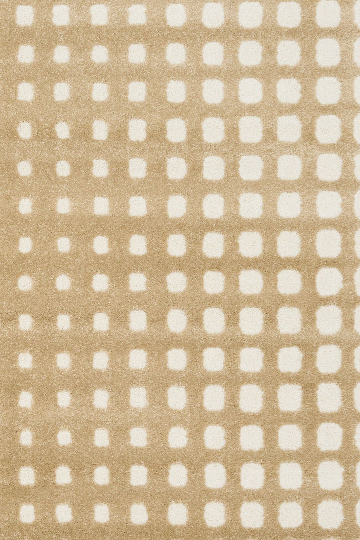 Detailed view of beige rug’s textured squares.