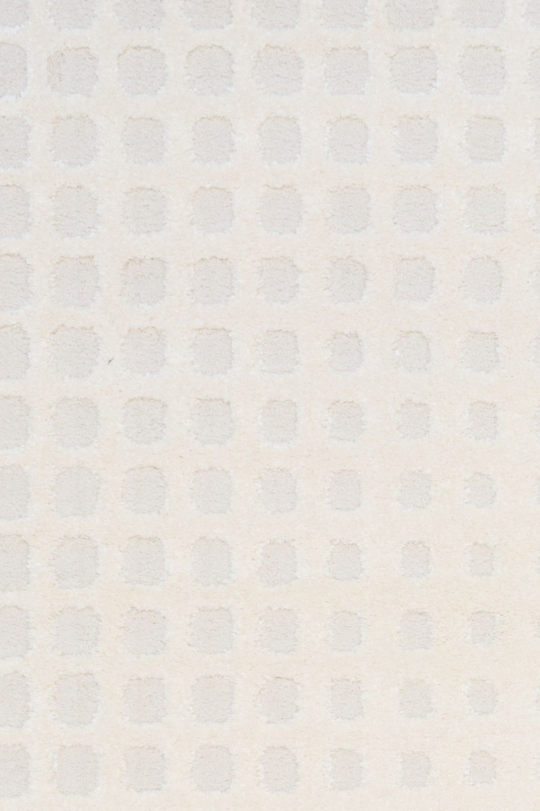 A close-up of the textured white rug pattern.