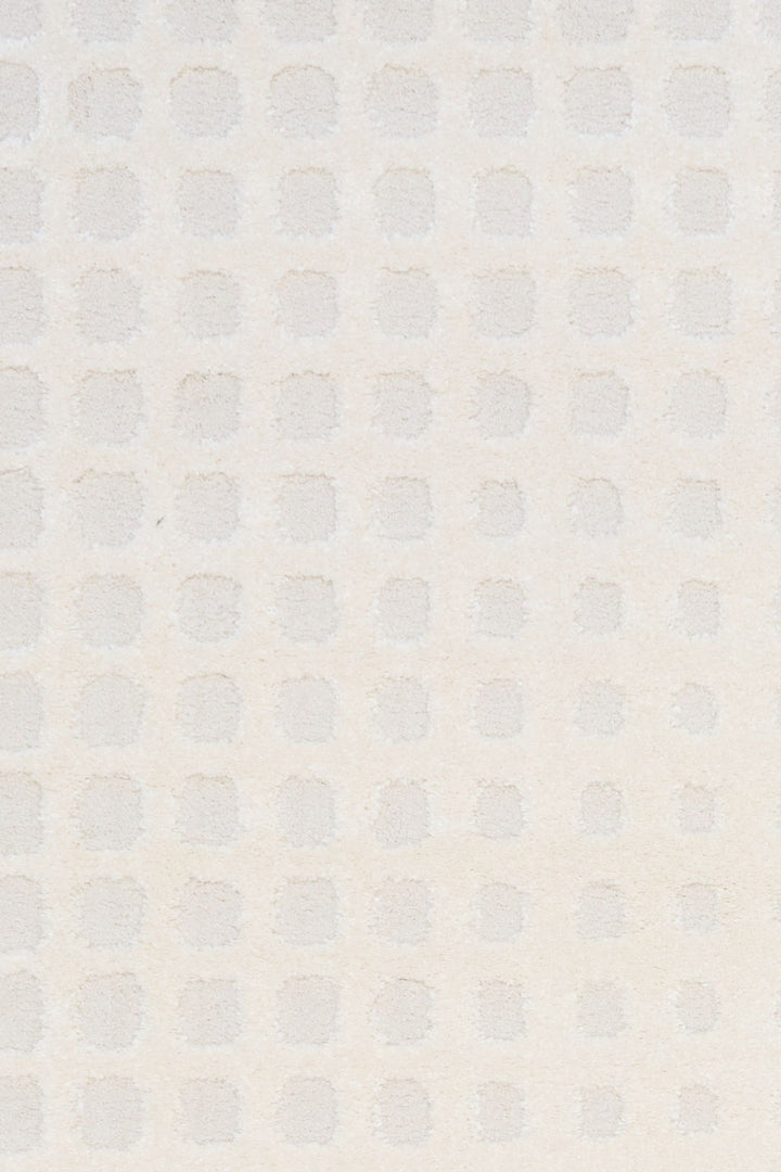 A close-up of the textured white rug pattern.