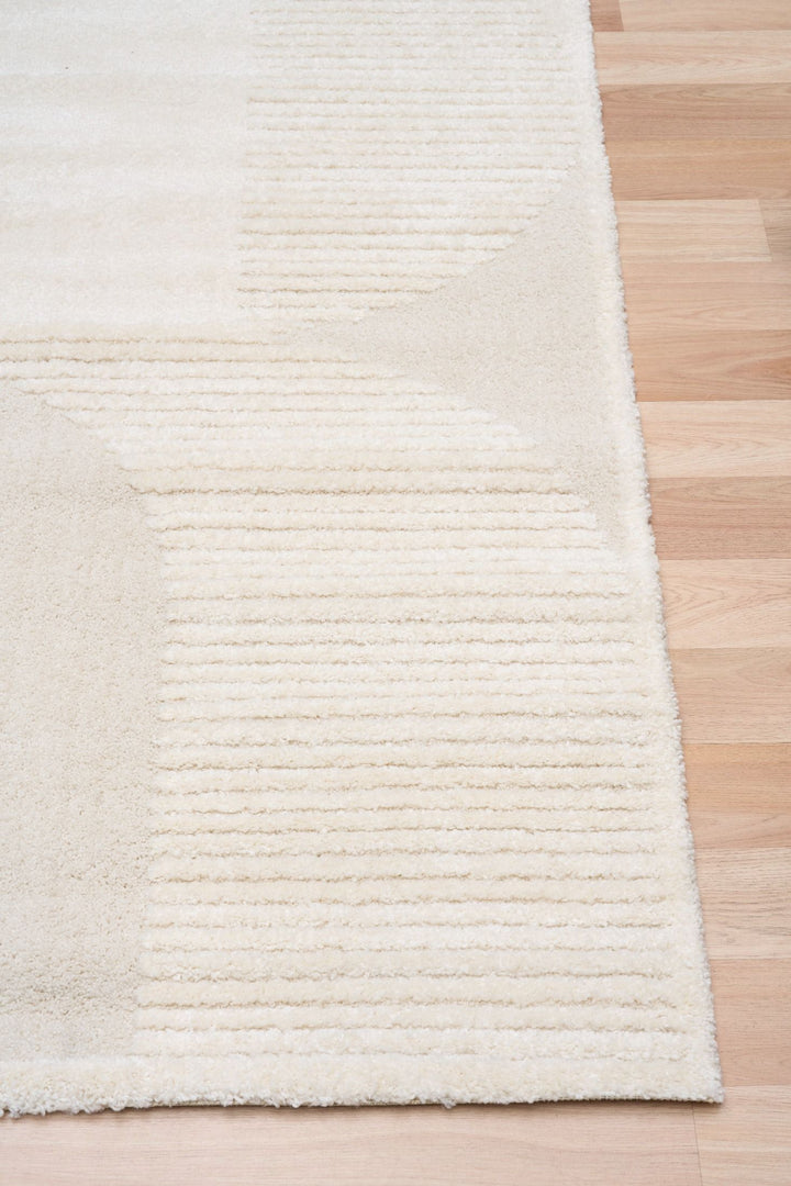 Cream rug corner with visible striped texture.