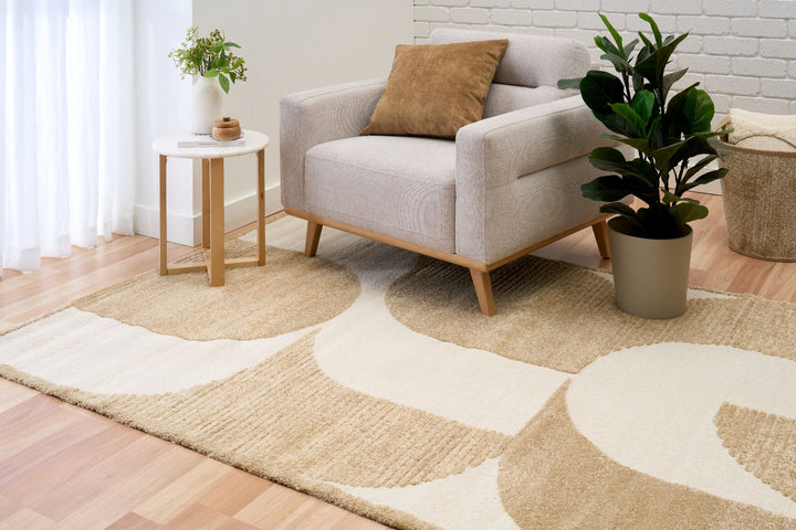 Modern rug under grey chair.
