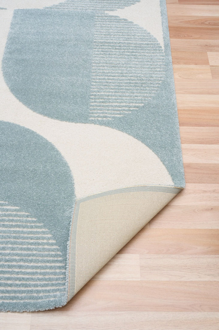 Rug corner folded showing backing material.