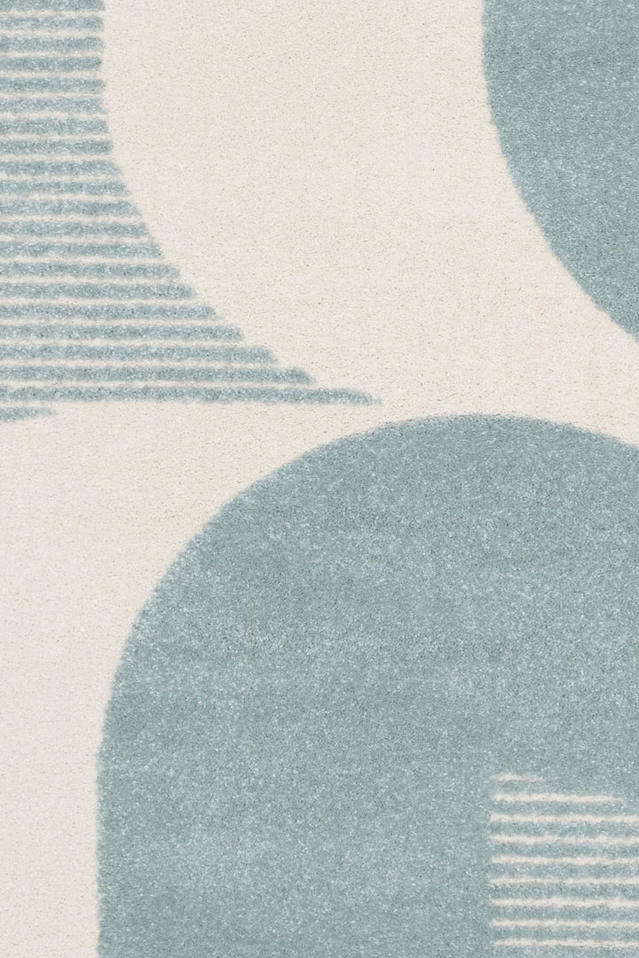 Close-up of rug pattern with stripes and curves.