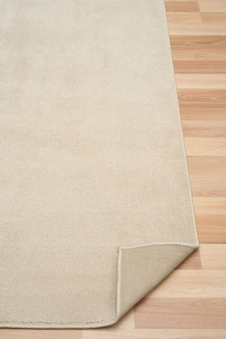 Plain ecru rug with folded corner.
