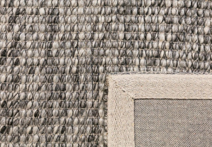 Close-up view of Dasha Dark Grey Wool Rug in round shape