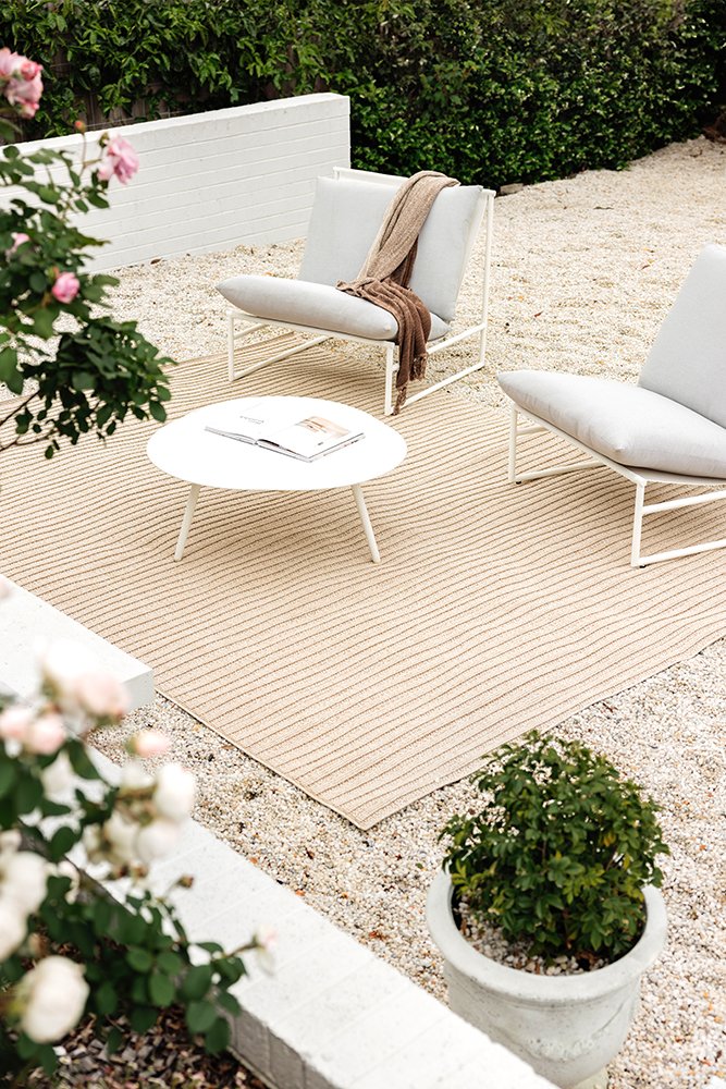 Outdoor rugs with chairs and plants decor