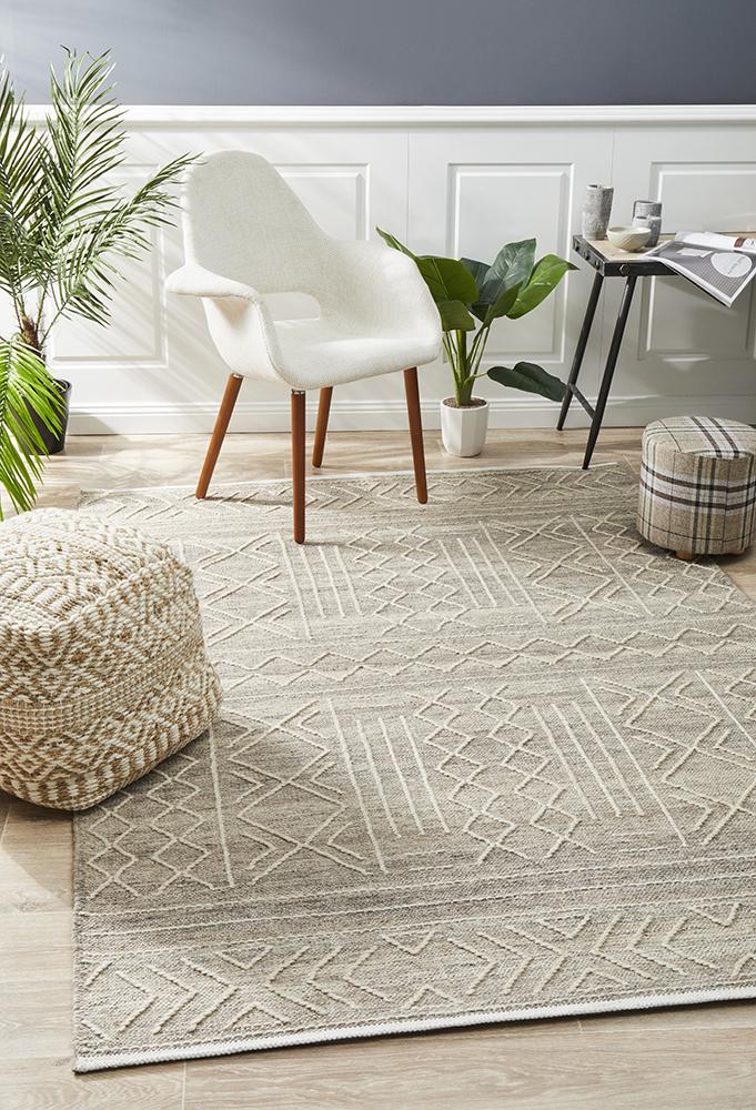 Neutral jute rug in a Melbourne living room with rattan furniture and natural light.