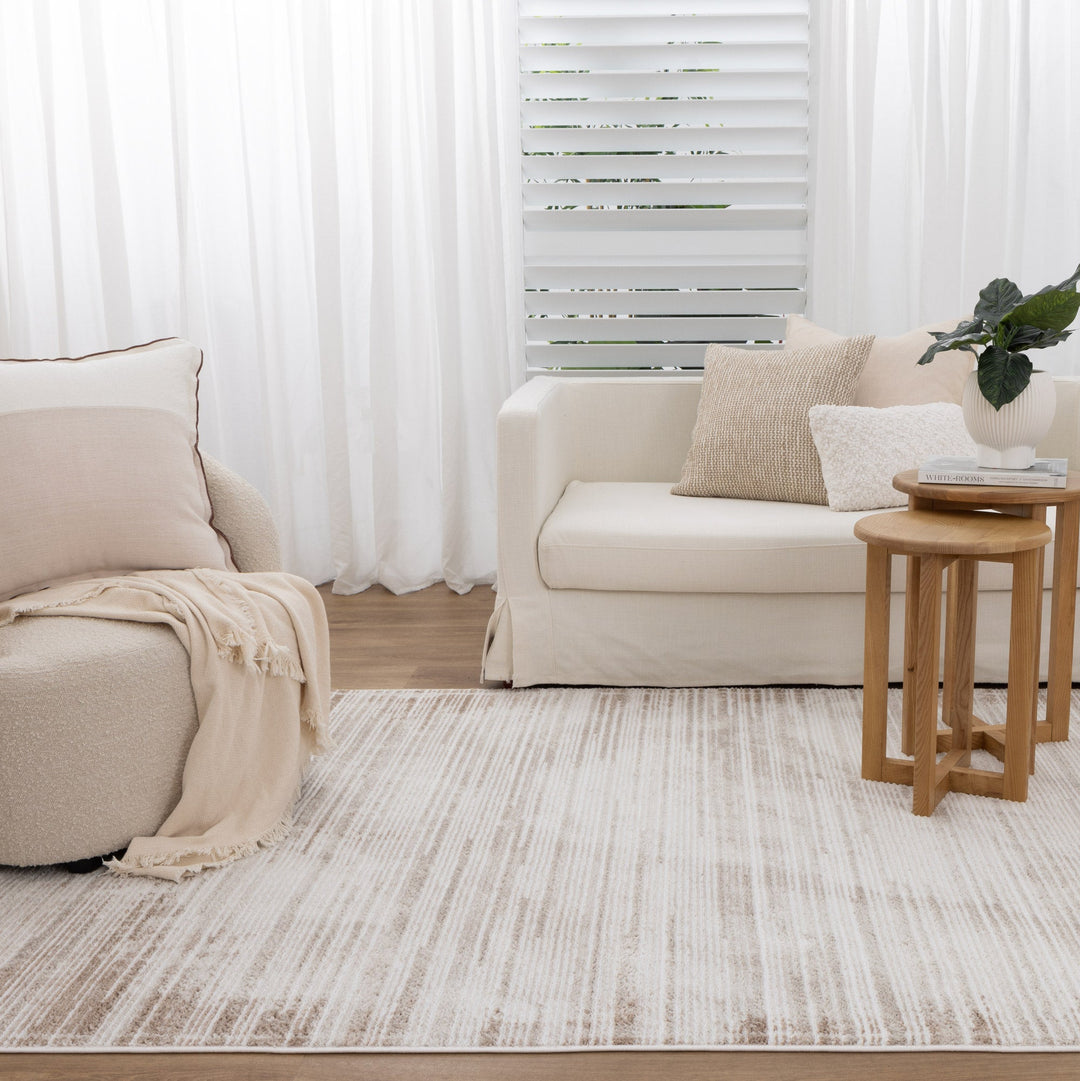 Stylish modern living room with a neutral striped area rug, perfect for adding warmth and texture to homes in Mill Park.