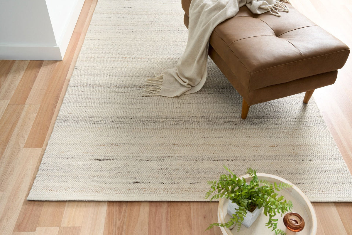 Hand-knotted wool rug in warm hues placed under a vintage coffee table