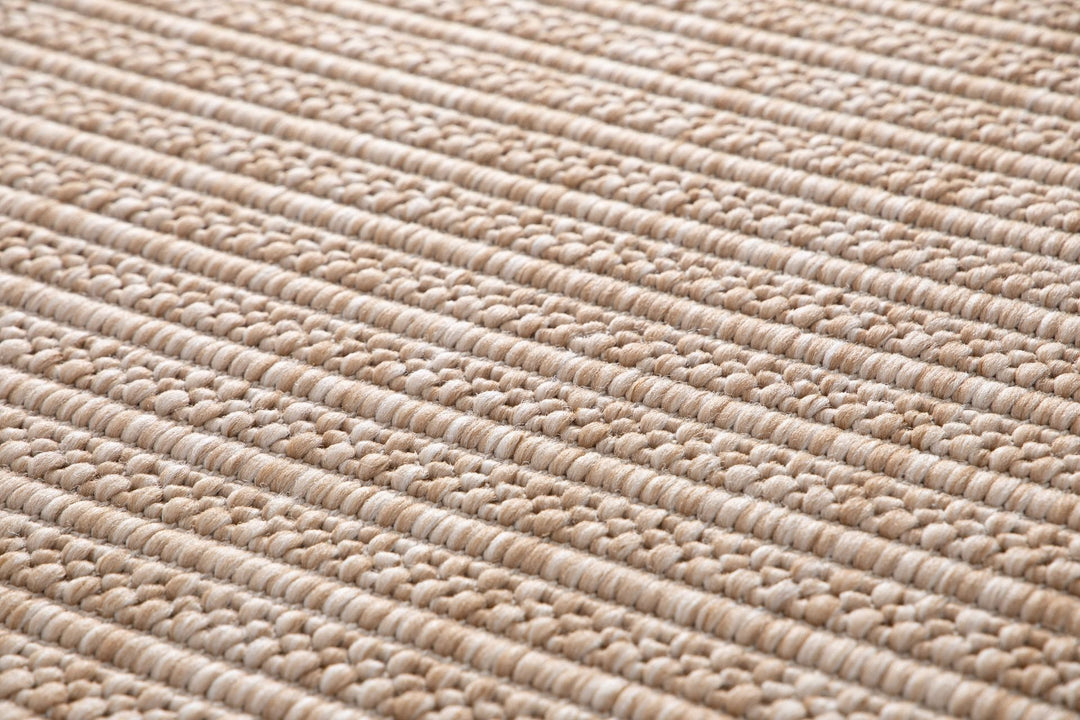 Macro close-up of Barton rug in Sand, showing chunky two-tone beige and ivory basketweave loops.