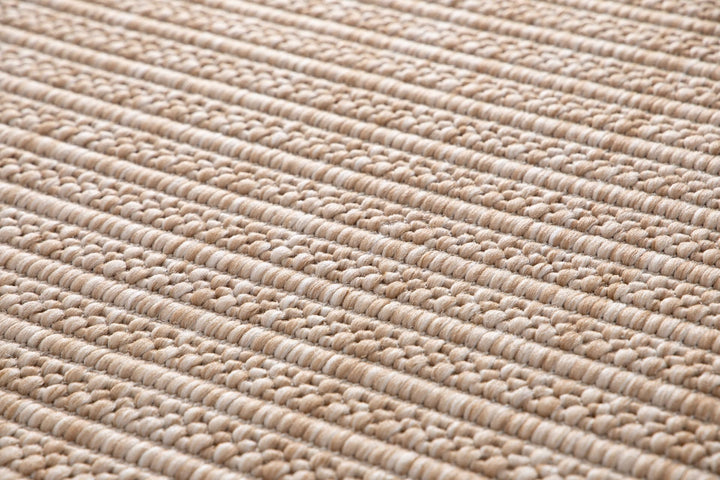 Macro close-up of Barton rug in Sand, showing chunky two-tone beige and ivory basketweave loops.