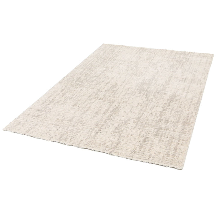 Angled view of a rectangular beige rug.