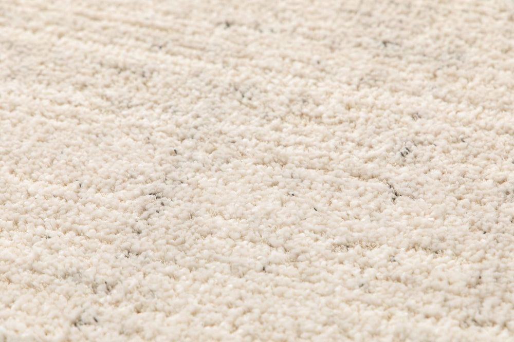 Textured close-up of beige rug.