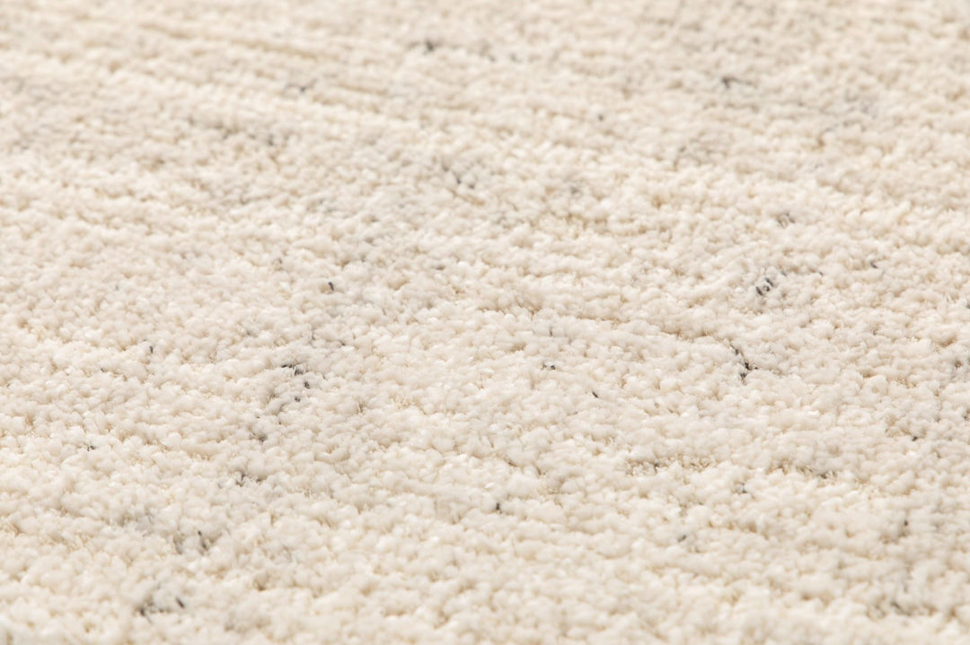 Textured close-up of beige rug.
