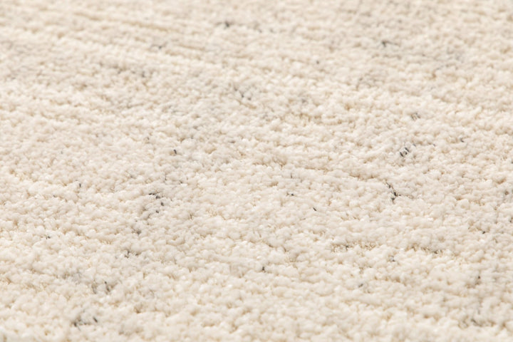Textured close-up of beige rug.