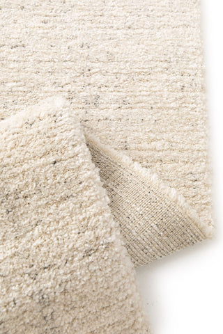 Folded corner showing rug backing.