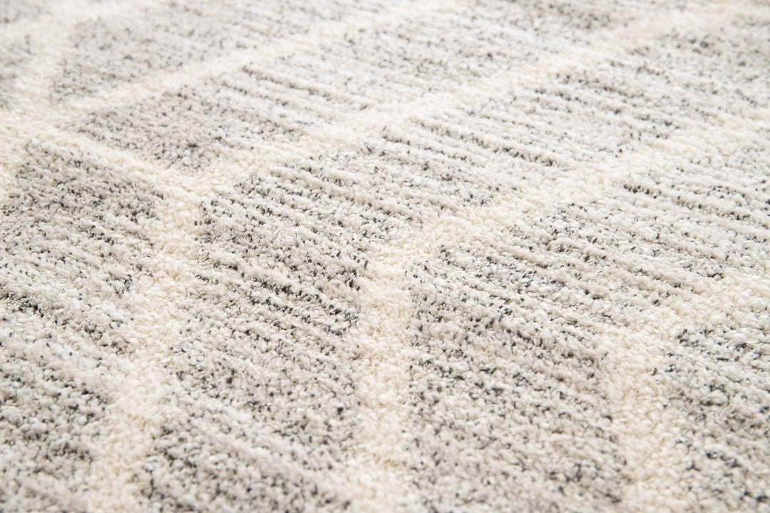Texture detail of a grey and white rug.