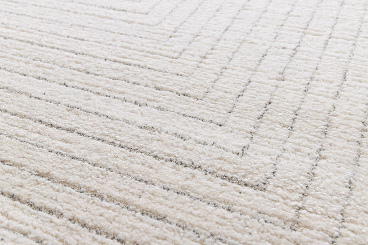 Close-up detail of a cream rug with raised textured stripes.