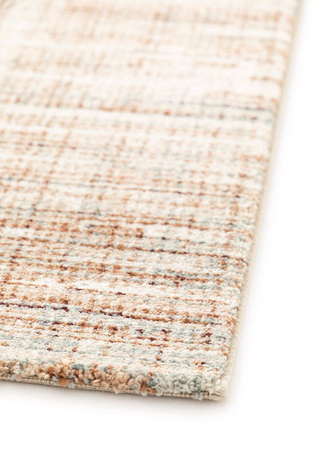 Close-up of the corner of a beige and brown rug.